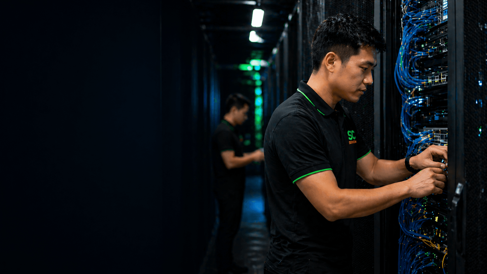 Servcom Solutions IT engineers managing server rack and network cabling in a data centre in Malaysia
