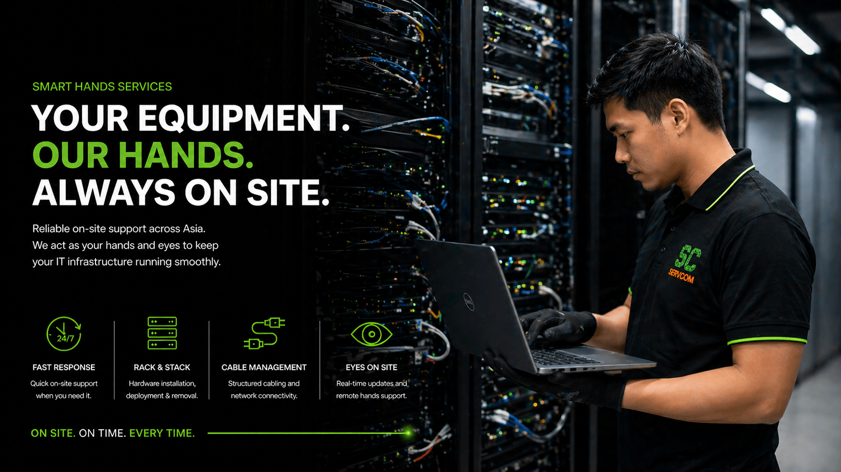 Servcom engineer with laptop managing IT infrastructure in data centre corridor
